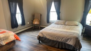 A bedroom with a bed, a chair, and a dresser. - Creek Side Home-Fly Fishing, Nature Walks (Boiling Springs)