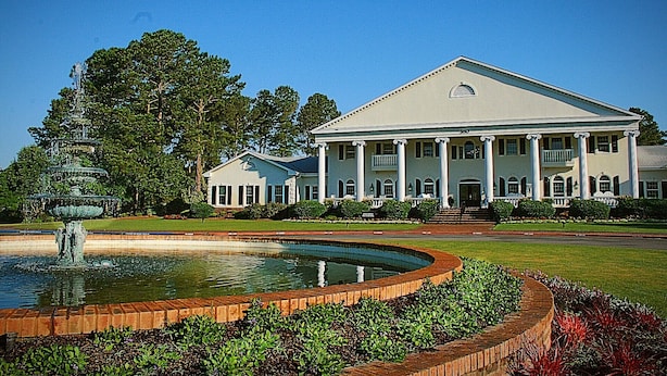 A large, stately building with a symmetrical facade, large columns, and a central entrance.