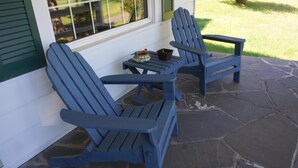Two Adirondack chairs on a stone patio with a small table and a bowl between them. - Classic Cottage w/Beautiful Catskill View, on
5 peaceful acres. Weekly discount! (Stone Ridge)