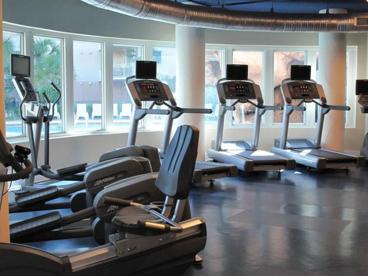 A gym with treadmills, ellipticals, and stationary bikes.