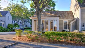 A residential house with a porch, a tree, and a mailbox. - Private condo in Maushop. Steps to beach, ocean, Popponesset Inn and Marketplace (Mashpee)