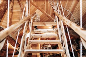 A wooden interior with a wooden staircase and a chandelier. - Finnish Kota Cave Orjobet (Collonges-sous-Salève)