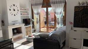 A modern living room with a sofa, TV, and decorative items. - App,  2 bedroom ,2 terraces, Swimming pool + Parking, Wifi (Algorfa)