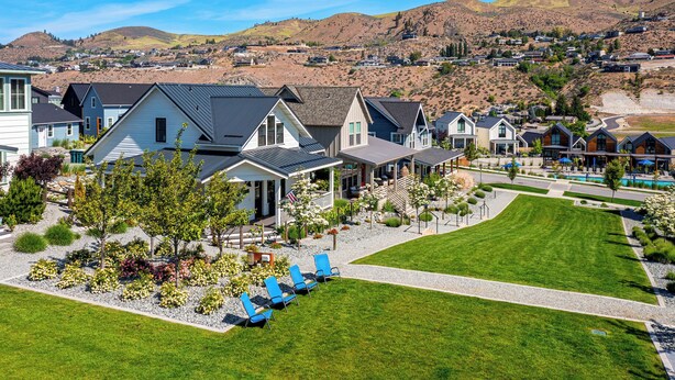 A residential area with houses, a swimming pool, and a well-maintained lawn.