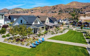 A residential area with houses, a swimming pool, and a well-maintained lawn.