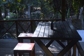 Enjoy al fresco dining on the deck, surrounded by lush greenery.