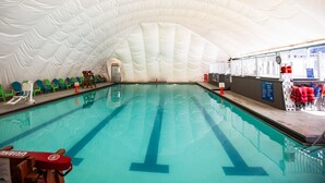 An indoor swimming pool with clear lanes, a lifeguard chair, and a white dome ceiling. - Smuggler's Notch Resort by Resort Stay (Jeffersonville)