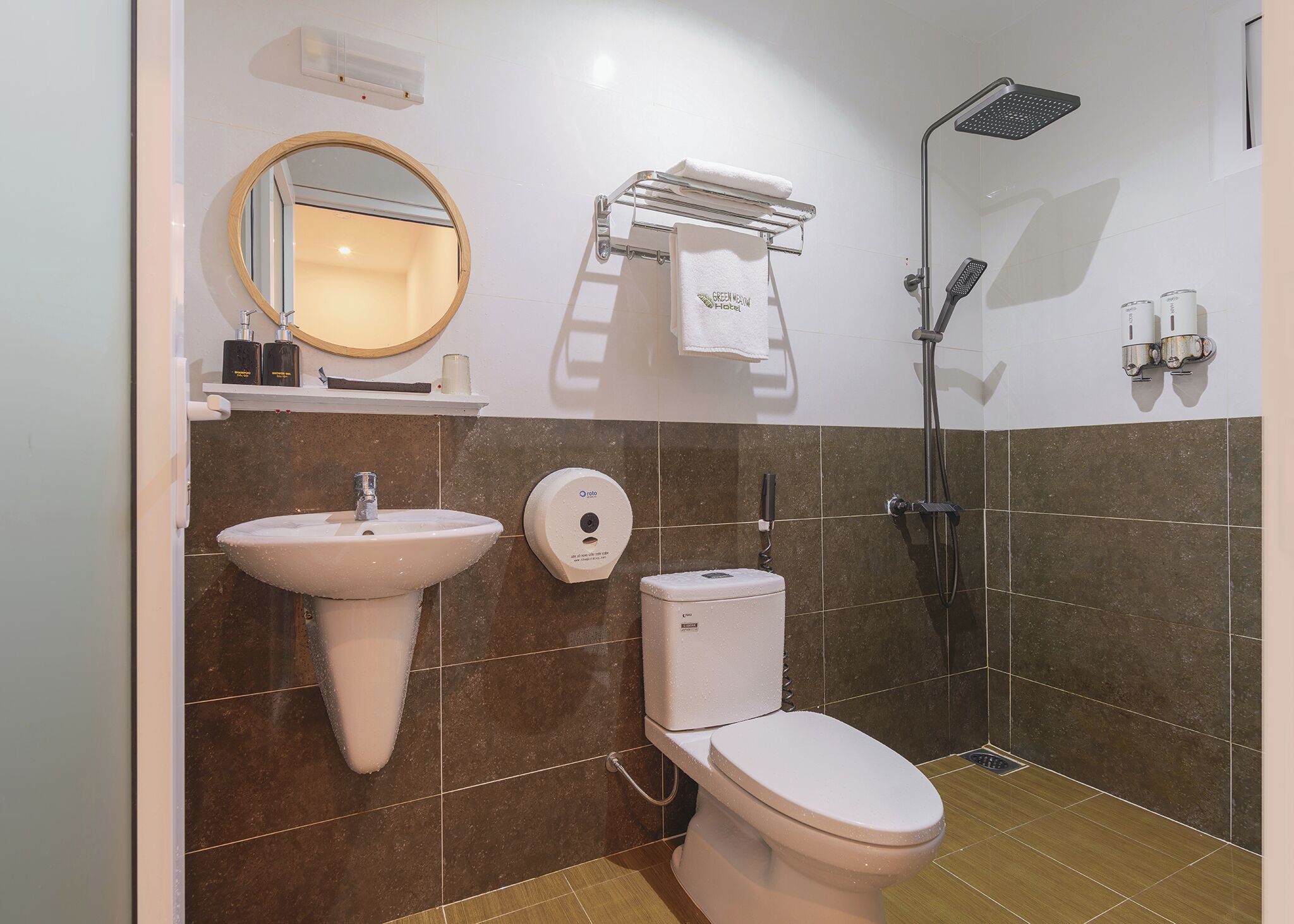 A bathroom with a sink, toilet, and shower.