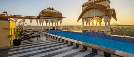 Outdoor pool, open 7:00 AM to 10:00 PM, pool umbrellas