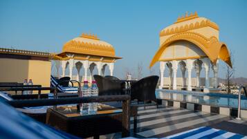 Outdoor pool, open 7:00 AM to 10:00 PM, pool umbrellas