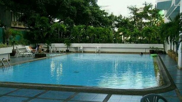 An indoor swimming pool with tiled flooring and lounge chairs around the perimeter. - Ploenchit Superb Location, 86sqm, nearby Bumrungrad Hospital - minimum 30 days (Khwaeng Makkasan)