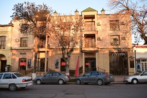 A building with a hotel sign, a restaurant, and a cinema.