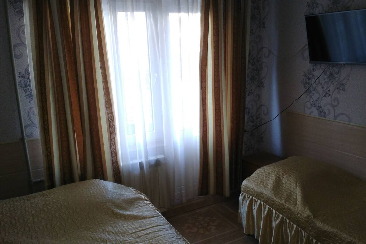 Desk, iron/ironing board, bed sheets