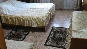 Desk, iron/ironing board, bed sheets