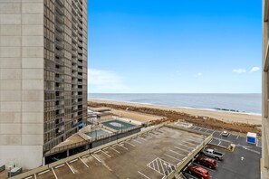 A parking area with a view of the beach and ocean.