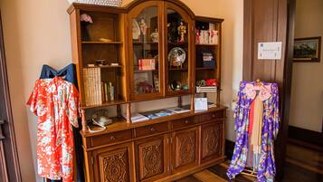 A wooden cabinet with glass doors, books, and decorative items.