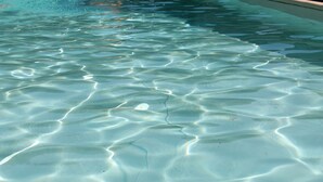 Una piscina cristalina con ondulaciones y reflejos visibles en la superficie del agua.