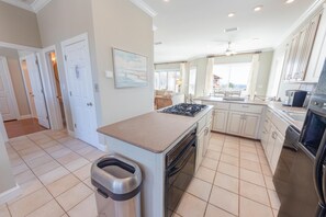 Enjoy cooking in this well-equipped kitchen with a central island, gas stove, oven, and dishwasher.