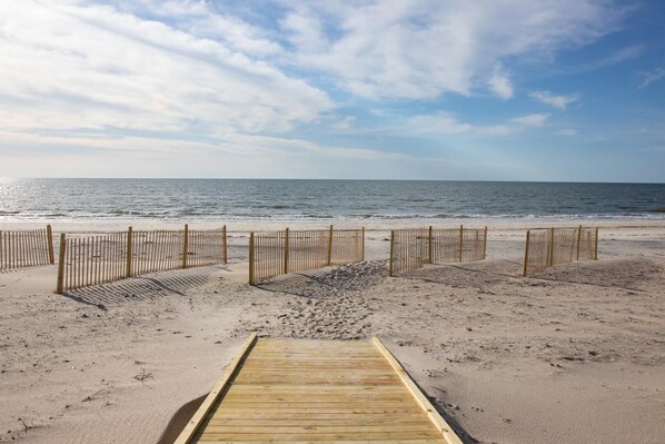 Walk along the beach to the wooden boardwalk and enjoy the ocean views.