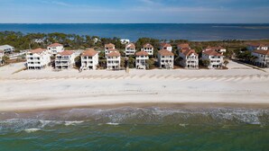 A beachfront hotel with multiple-story buildings, a sandy beach, and ocean views. - Beach & Bay views! 4BR/3.5BA, Elevator, Com Pool/Tennis Court (St. George Island)