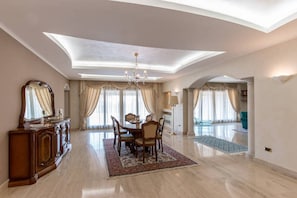 Enjoy a stylish space with a dining area, ornate cabinet, and expansive views from the balcony.