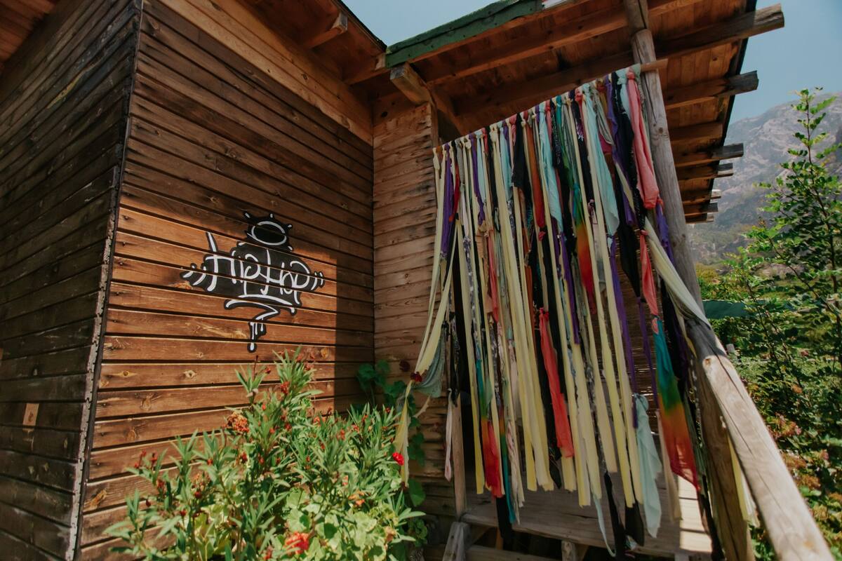 A wooden cabin with a sign reading "Hotel".
