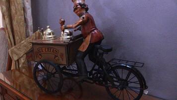 A vintage ice cream vendor figurine on a wooden table.