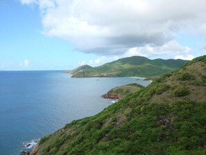 A coastal landscape with hills and a body of water. - Secluded skytop retreat with stunning sea and mountain Views (Falmouth Harbor)