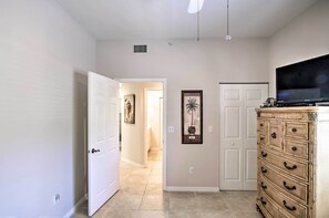 Enter a serene space with a large flat-screen TV and a framed artwork on the wall.