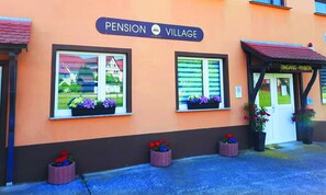 A building with a sign reading "Pension Village" and a door labeled "Eingang - Pension". - Pension Village (Naumburg)