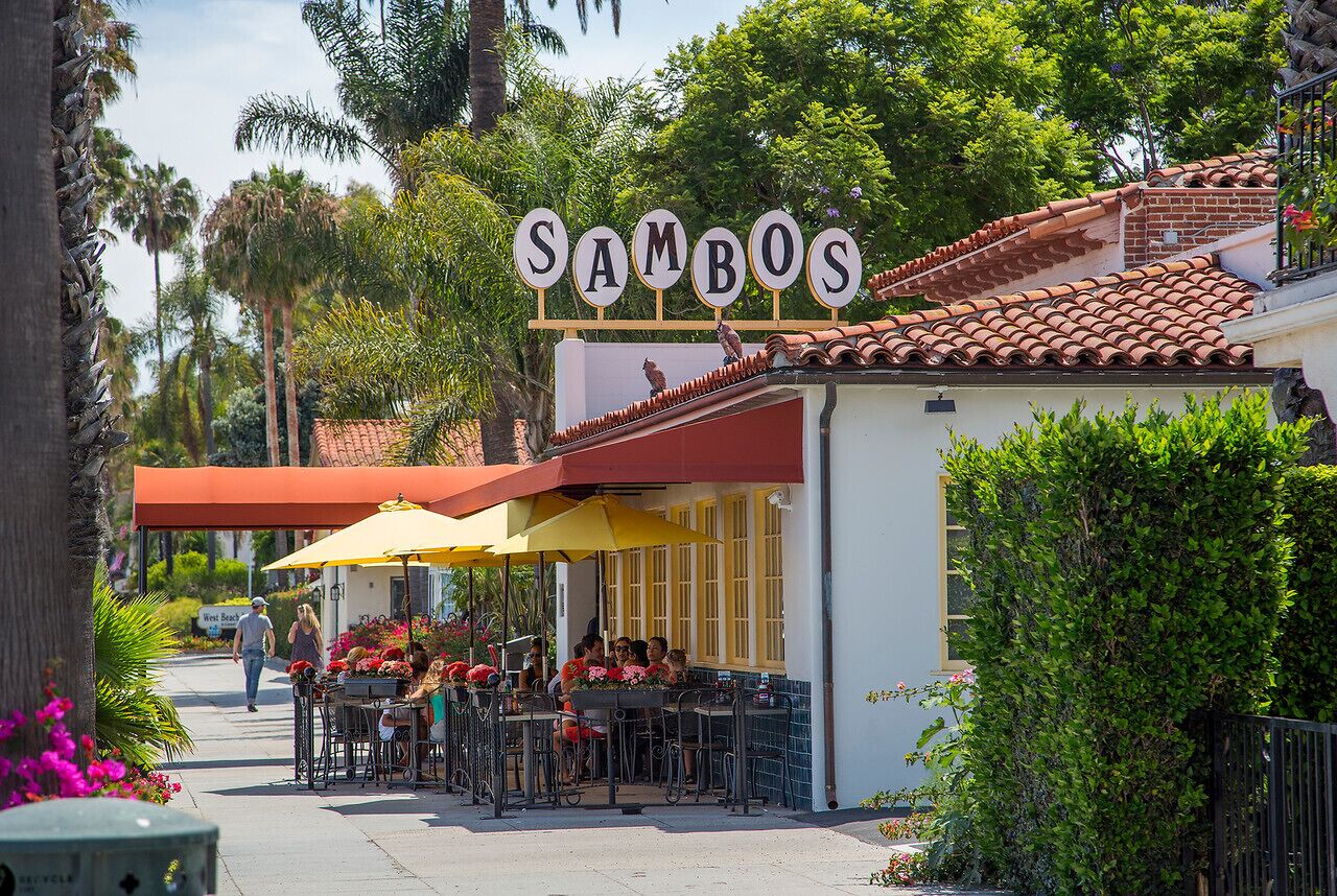 A restaurant named 'Sambos' with outdoor seating and a red awning.