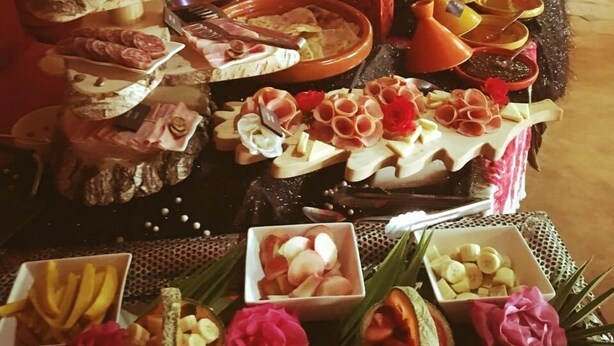 A buffet with various food items and a decorative backdrop. - Villa 865 + (Marrakech)