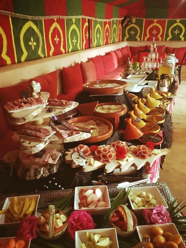 A buffet with various food items and a decorative backdrop. - Villa 865 + (Marrakech)