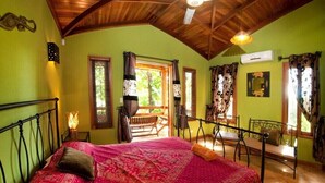 A room with a bed, a wooden ceiling, a window, and a chair. - Quinta Teca with two pools near Playa Hermosa beach (Playa Hermosa)