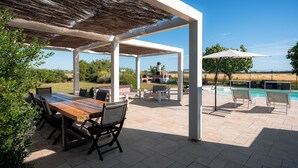 A covered patio with a pool, outdoor furniture, and a view of the landscape. - Farmhouse with swimming pool 2 km away from the sea (Piombino (LI))