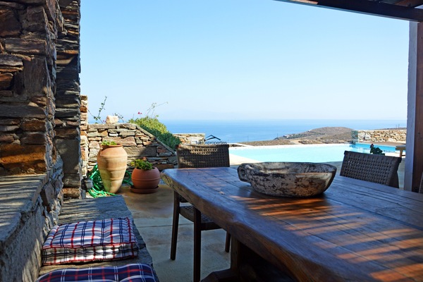 The shaded dining area with a pool an sea view
