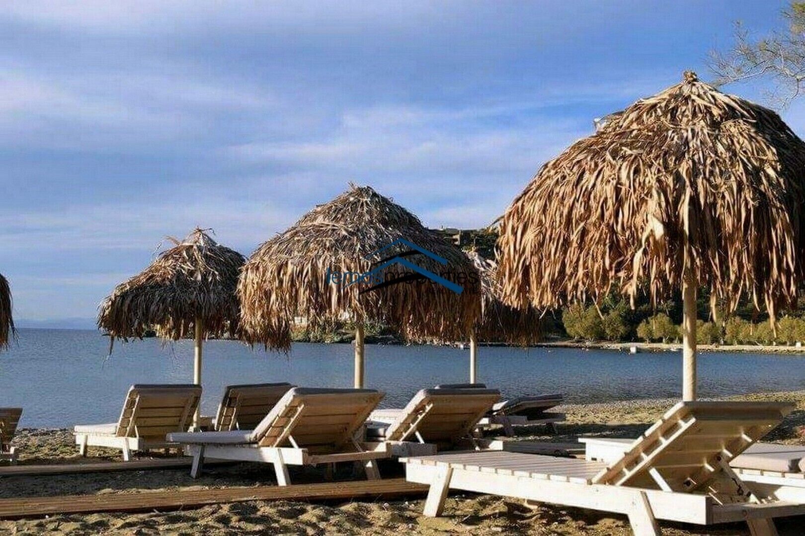 Half of the beach is organized with sunbeds and umbrellas.