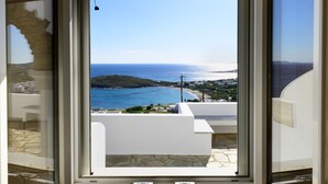 A view from a window with a view of a coastal area, including a beach and buildings.