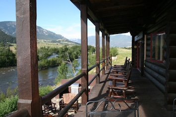 Long upper deck overlooking the Stillwater River & stone patio w/outdoor kitchen