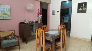 Enjoy meals in this cozy dining area with a glass-top table and comfortable seating.
