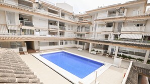 A multi-story residential building with a central swimming pool, balconies, and outdoor seating areas. - A93 SENIA ESC C  2º I (Calpe)