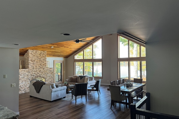Large open main living area! Stone fireplace and windows overlooking the lake.