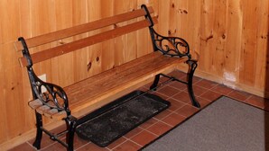 A wooden interior with a bench and two windows. - Spacious Sugarbush Retreat - Wood Stove, Outdoor Pool, 5 Mins to Sugarbush (Warren)