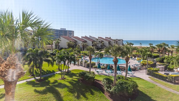 A resort with a pool, palm trees, and a beach view. - Siesta Dunes 5-303, Come enjoy our little piece of Paradise! (Siesta Key)