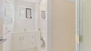 A bathroom with a bathtub, a toilet, and a sink.
