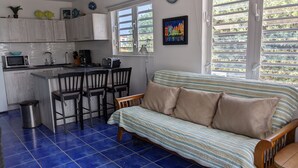 A compact living space with a kitchenette, a sofa, and a dining area. - DIVE FROM YOUR DOORSTEP!  Oceanview Townhome with Diving Amenities at Marazul E1 (Sabana Westpunt)