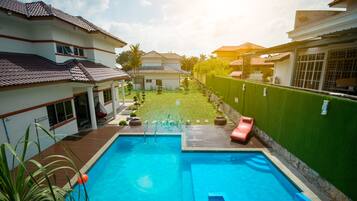 Enjoy a refreshing swim in the pool surrounded by a beautifully landscaped garden.