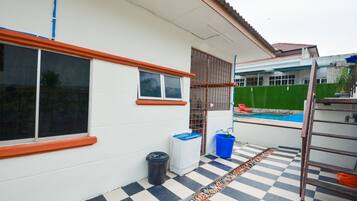 A house with a checkered floor, a swimming pool, and a ladder.