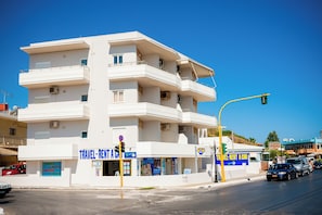 A multi-story building with a travel rental car service. - Lily of Crete 2 - Seaview & Beachfront Apartments (Galatas)