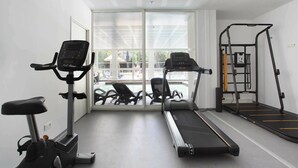 A gym with treadmills, an elliptical, and a weight machine. - Apartment in Cavalaire-sur-Mer near Beach (Cavalaire sur Mer)